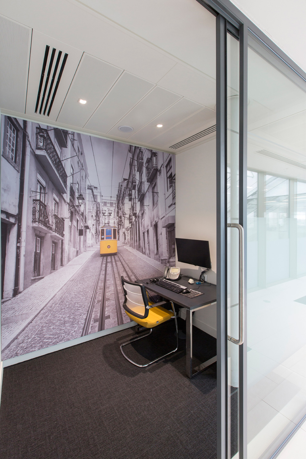 Monochromatic office interiors fit out in London - quiet room with supergraphic of Lisbon tram