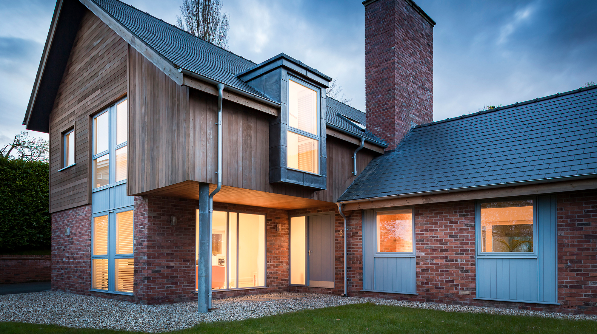 Contemporary residential property - front view of private house exterior at dusk