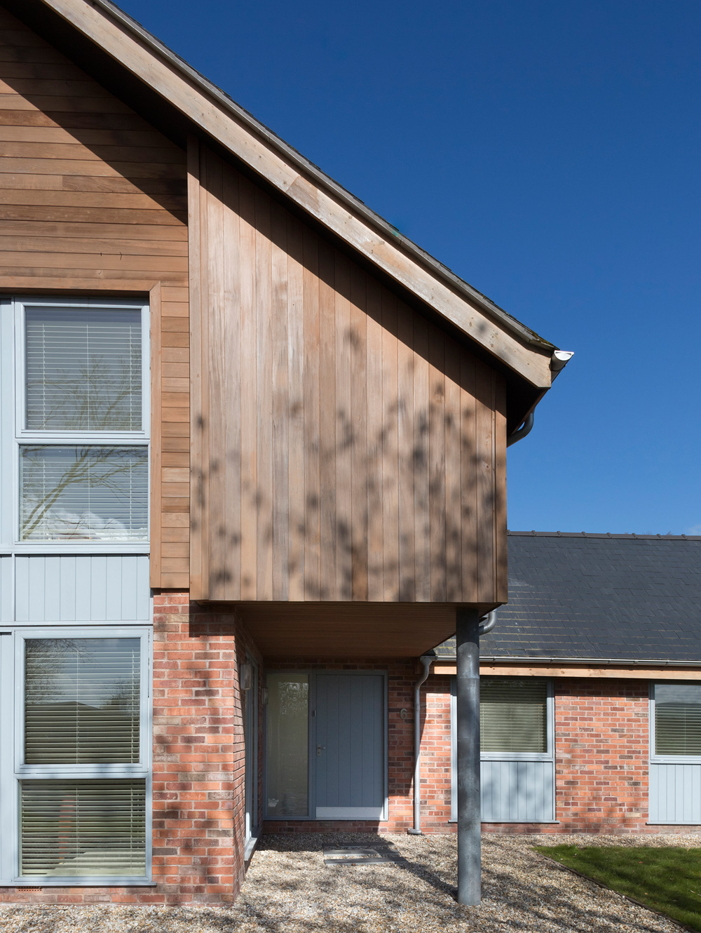 Contemporary residential property - close up of front view showing cedar and zinc cladding