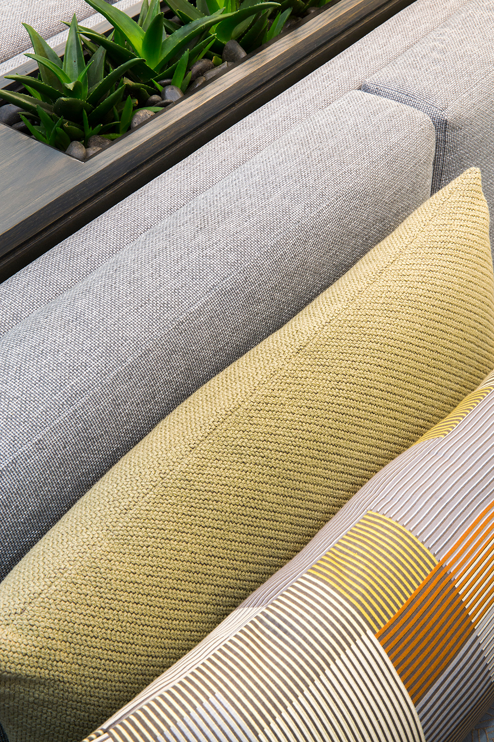 London headquarters interior architecture redesign - cloe up of reception booth seating with planters and cushions