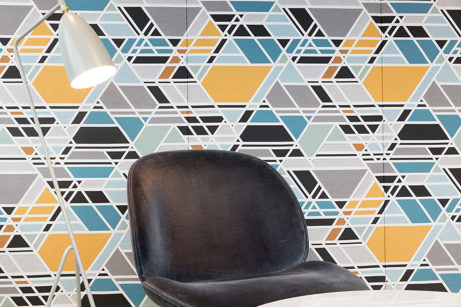 London headquarters interior architecture redesign - feature fabric wall, velvet Gubi chair and Gubi floor standing lamp