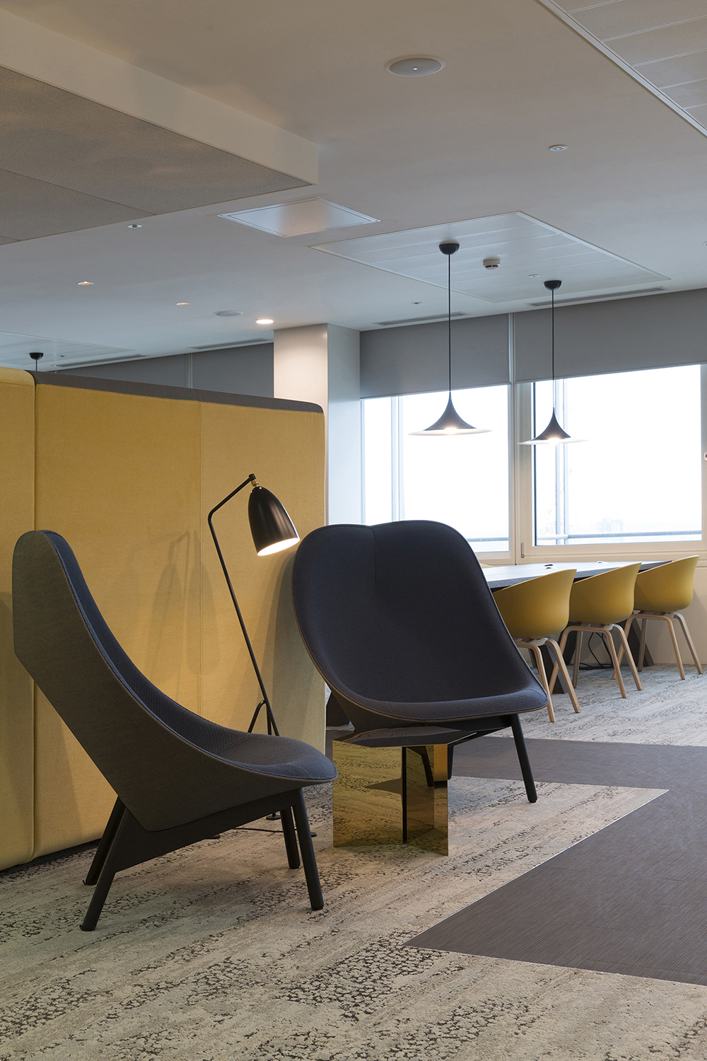 London headquarters interior architecture redesign - highback chairs provide an ad-hoc meeting area