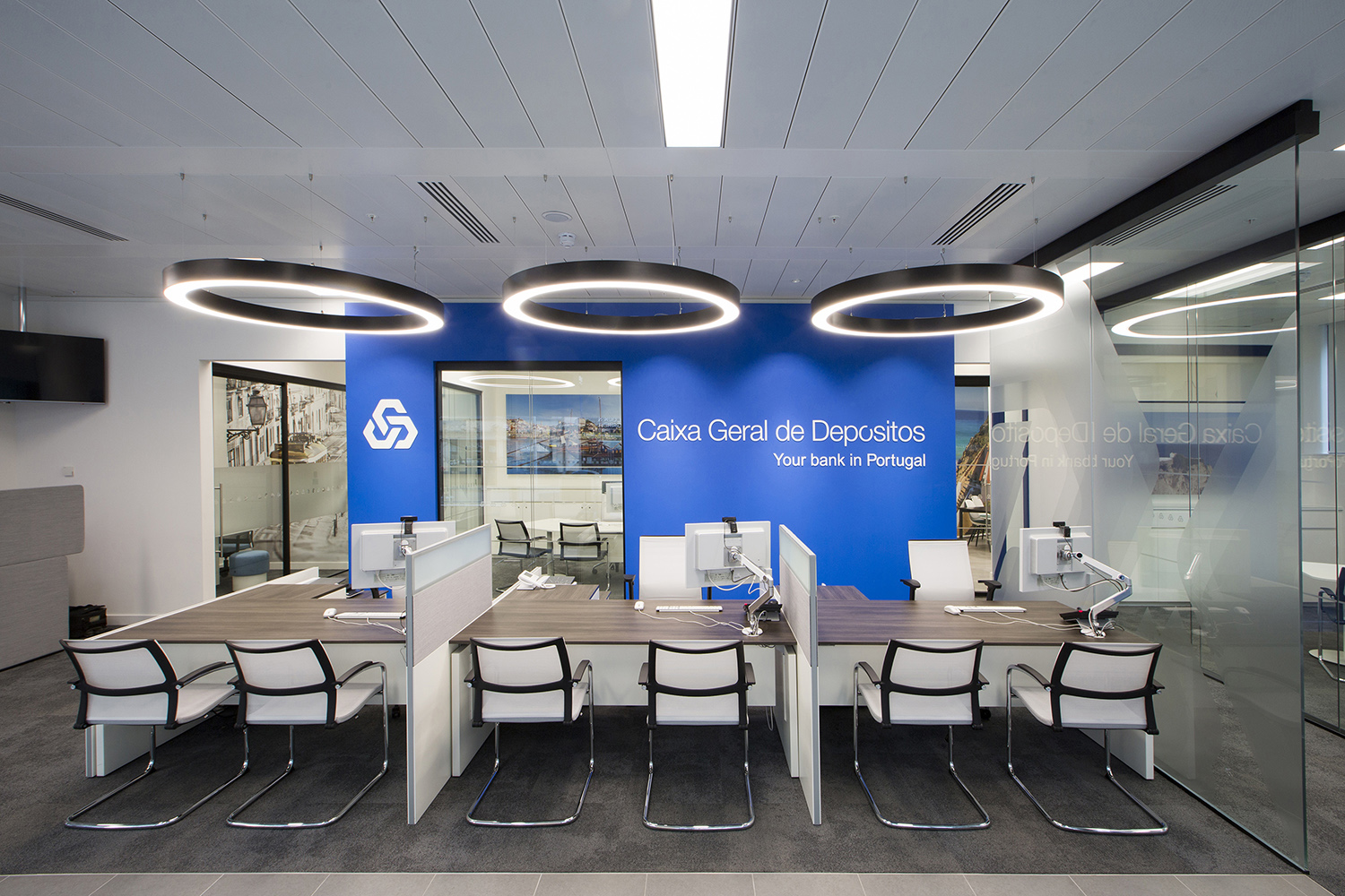 Design and branding for Caixa customer suite in London - customer service area with feature lighting and branded wall for on-street presence
