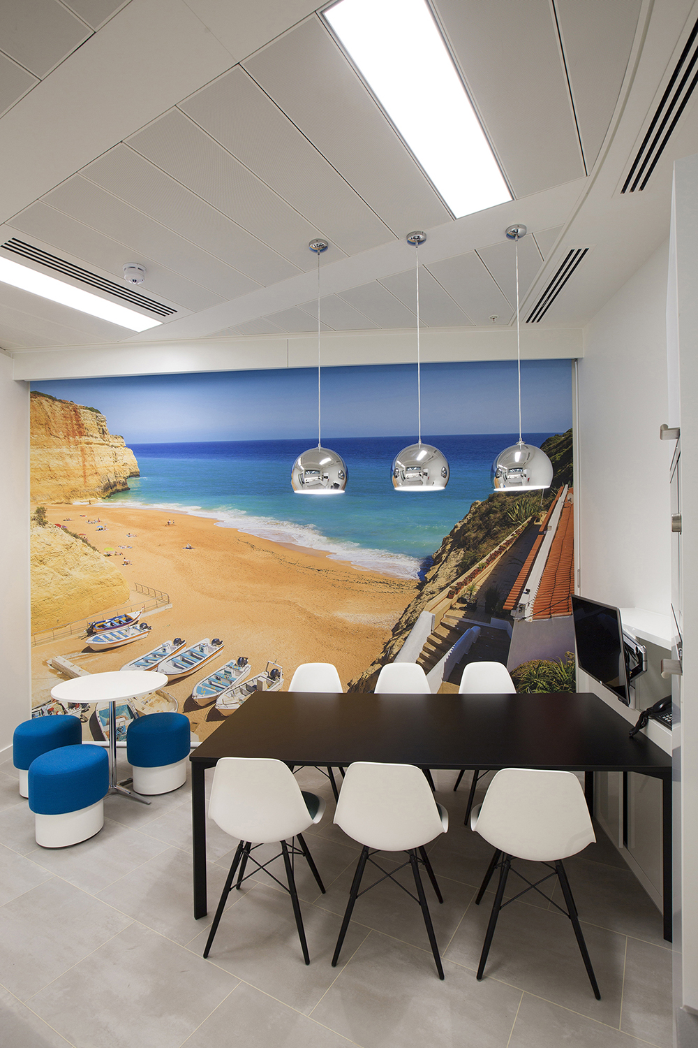 Design and branding for Caixa customer suite in London - break out area featuring large super graphic wall of Portuguese beach
