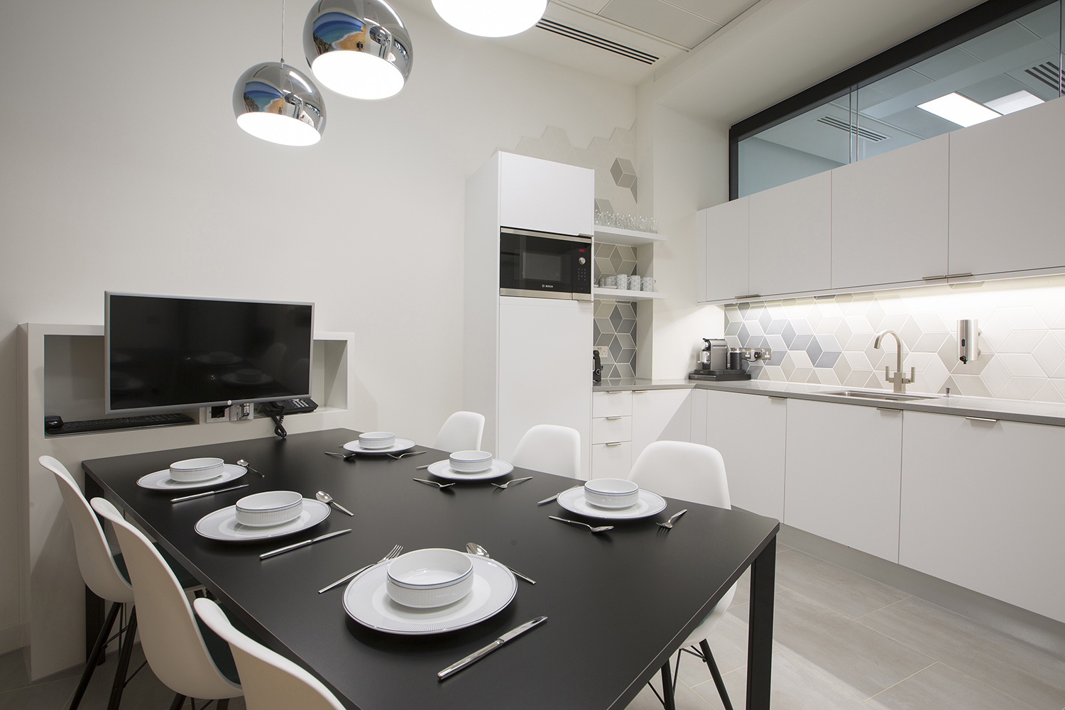 Design and branding for Caixa customer suite in London - monochromatic break out area and kitchen