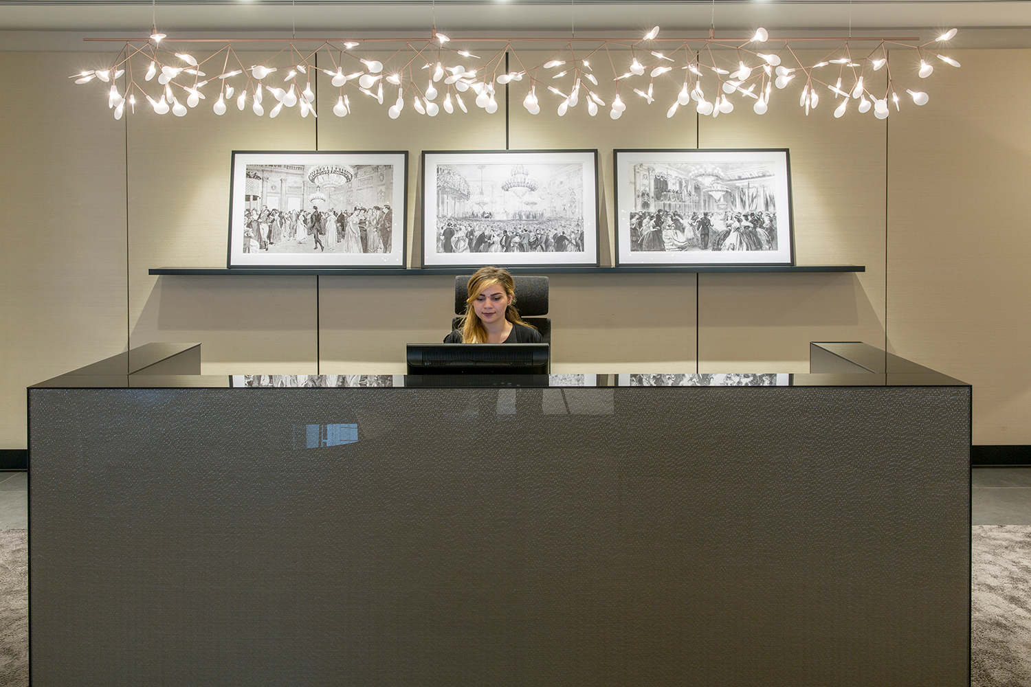 Plush Mayfair reception and waiting area design - reception desk with feature lighting and artwork